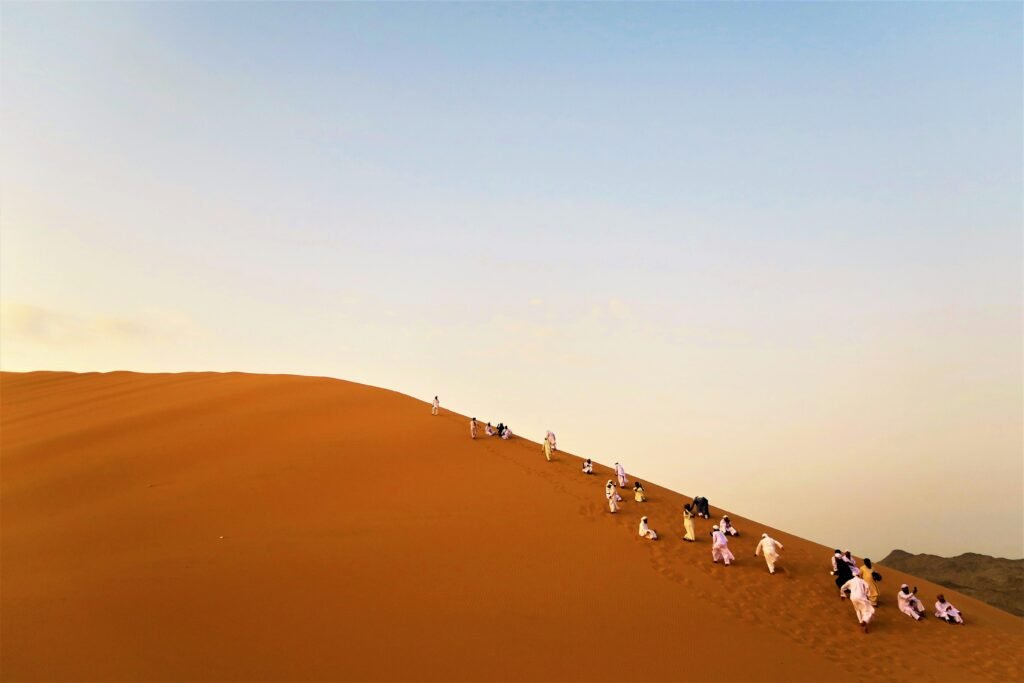 Photo of People Walking on Desert