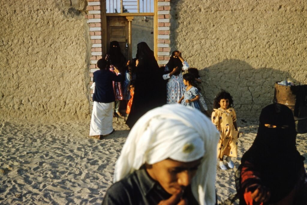 Bedouins Standing by Gate in Wall